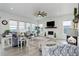 Bright living room with fireplace, ceiling fan, large windows, and stylish decor at 39405 Stockton Cir, Elizabeth, CO 80107