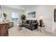 Bright living room features a comfortable couch, accent chair, and natural light from the window at 39405 Stockton Cir, Elizabeth, CO 80107