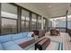 Cozy covered patio with comfortable seating, fire pit, and outdoor dining area at 39405 Stockton Cir, Elizabeth, CO 80107