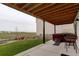Covered patio with hot tub, seating area, and view of the backyard and distant homes at 39405 Stockton Cir, Elizabeth, CO 80107
