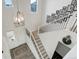 Bright entry staircase with modern light fixture and decorative picture gallery at 39405 Stockton Cir, Elizabeth, CO 80107