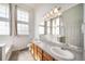 Lovely bathroom featuring double sinks, tile floors, and a well-lit vanity mirror at 3000 E 112Th Ave # 56, Northglenn, CO 80233
