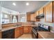 The kitchen features wooden cabinetry and stainless steel appliances, with an eat-in bar at 3000 E 112Th Ave # 56, Northglenn, CO 80233