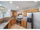 Well-lit kitchen features stainless steel appliances and warm wood cabinets at 3000 E 112Th Ave # 56, Northglenn, CO 80233
