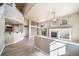 Large living room featuring wood floors, a fireplace, and an eat-in kitchen bar at 3000 E 112Th Ave # 56, Northglenn, CO 80233