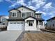 Two-story home with gray siding, white brick accents, and a two-car garage at 4026 N Irvington St, Aurora, CO 80019