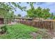 The spacious backyard has a brick patio and wooden fence, perfect for outdoor enjoyment and privacy at 7995 Robin Ln, Denver, CO 80221