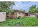 The backyard showcases a brick house, wooden fence, and lush greenery, offering a serene retreat at 7995 Robin Ln, Denver, CO 80221