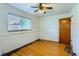 Bedroom with hardwood floors, a ceiling fan and a window for natural light at 7995 Robin Ln, Denver, CO 80221