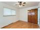 Bedroom boasting hardwood floors, a ceiling fan and a large closet at 7995 Robin Ln, Denver, CO 80221