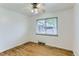 Bedroom featuring hardwood floors, a ceiling fan and a large window at 7995 Robin Ln, Denver, CO 80221