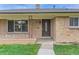 Inviting front entrance with a decorative door and brick facade at 7995 Robin Ln, Denver, CO 80221