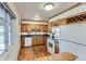 Bright kitchen with wood cabinets and a view to the outside at 7995 Robin Ln, Denver, CO 80221