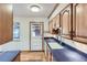 Traditional kitchen featuring wood cabinets, laminate countertops, and a door leading to the exterior at 7995 Robin Ln, Denver, CO 80221