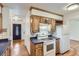 Functional kitchen with wood cabinets and appliances at 7995 Robin Ln, Denver, CO 80221