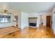 Spacious living room with hardwood floors and a cozy fireplace at 7995 Robin Ln, Denver, CO 80221