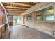 Covered patio with brick exterior, tile floor, and wood lattice, seamlessly integrated with the home at 7995 Robin Ln, Denver, CO 80221