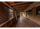 Enclosed patio featuring a wood pergola and a brick exterior under an abundance of natural light at 7995 Robin Ln, Denver, CO 80221