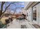 Backyard patio with outdoor seating, mature trees, and a fenced yard at 5689 S Youngfield Way, Littleton, CO 80127