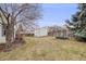 Fenced backyard with storage shed and swing, perfect for and outdoor activities at 5689 S Youngfield Way, Littleton, CO 80127