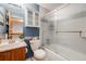 Renovated bathroom with glass shower, toilet, vanity, and mirrored cabinet at 5689 S Youngfield Way, Littleton, CO 80127