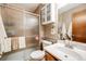 Bathroom featuring a glass shower, toilet, vanity, and mirrored cabinet at 5689 S Youngfield Way, Littleton, CO 80127