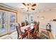 Cozy dining room with a classic wooden table, six chairs, and access to the backyard for outdoor dining at 5689 S Youngfield Way, Littleton, CO 80127