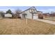 Daytime view of a charming two-story home with a well-manicured lawn and a convenient two-car garage at 5689 S Youngfield Way, Littleton, CO 80127