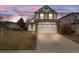 Charming two-story home with a well-manicured lawn and two-car garage, perfect for a growing Gathering at 5689 S Youngfield Way, Littleton, CO 80127