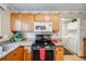 This kitchen features stainless steel appliances, and light oak cabinets at 5689 S Youngfield Way, Littleton, CO 80127