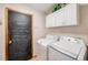 Practical laundry room with a blackboard door at 5689 S Youngfield Way, Littleton, CO 80127