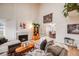 Bright living room with hardwood floors, a cozy fireplace, and elegant French doors leading to the dining area at 5689 S Youngfield Way, Littleton, CO 80127