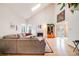Airy living room with vaulted ceilings, a cozy fireplace, and a comfortable sectional sofa for relaxation at 5689 S Youngfield Way, Littleton, CO 80127
