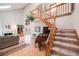 Sun-drenched living room with a fireplace and a staircase at 5689 S Youngfield Way, Littleton, CO 80127
