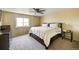 Bedroom featuring a ceiling fan, bed, and a window overlooking the outdoors at 4863 Quail Ct, Frederick, CO 80504