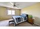 Bedroom with a ceiling fan, comfortable bed, and a bench near the window overlooking the outdoors at 4863 Quail Ct, Frederick, CO 80504
