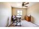 Bright bedroom featuring a ceiling fan, work desk, and a window overlooking the outdoors at 4863 Quail Ct, Frederick, CO 80504