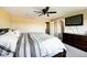Bedroom featuring a ceiling fan, TV, bed, and a closet at 4863 Quail Ct, Frederick, CO 80504