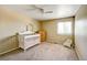 Bright Bedroom with a white crib, dresser and ceiling fan for a comfortable space at 4863 Quail Ct, Frederick, CO 80504