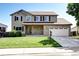 Charming two-story home featuring a well-maintained lawn, brick accents, and a two-car garage at 4863 Quail Ct, Frederick, CO 80504