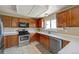 Spacious kitchen featuring stainless steel appliances, wood cabinetry, and ample counter space at 4863 Quail Ct, Frederick, CO 80504