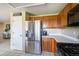 Kitchen featuring stainless steel appliances, white countertops, and wood cabinets at 4863 Quail Ct, Frederick, CO 80504