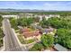A tranquil street view showcases well-maintained homes and verdant trees against a scenic mountain backdrop at 5703 Field St, Arvada, CO 80002