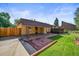 Spacious backyard with a covered patio and lush lawn, perfect for outdoor gatherings and relaxation at 5703 Field St, Arvada, CO 80002