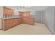 Basement wet bar featuring brick construction and wood cabinetry at 5703 Field St, Arvada, CO 80002