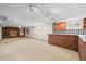 Basement rec room with carpet flooring, brick fireplace and wet bar at 5703 Field St, Arvada, CO 80002