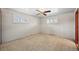 A carpeted bedroom with two windows and a ceiling fan provides natural light and comfort at 5703 Field St, Arvada, CO 80002