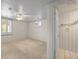 Bright bedroom showcasing carpet, a ceiling fan, and a view into the attached bathroom at 5703 Field St, Arvada, CO 80002