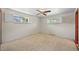 A carpeted bedroom with two windows and a ceiling fan provides natural light and comfort at 5703 Field St, Arvada, CO 80002