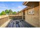 Wooden deck featuring a charming brick exterior and ample space for relaxing at 5703 Field St, Arvada, CO 80002